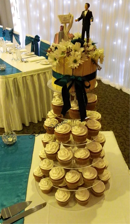 Classic White Chocolate Wedding Cupcake tower with 6 inch white chocolate shard cutting cake topped with fresh flowers. Bride & groom topper sold separately.