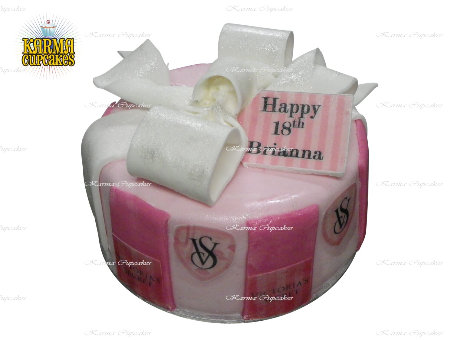 Victoria's Secret round cake with sugar bow and edible message