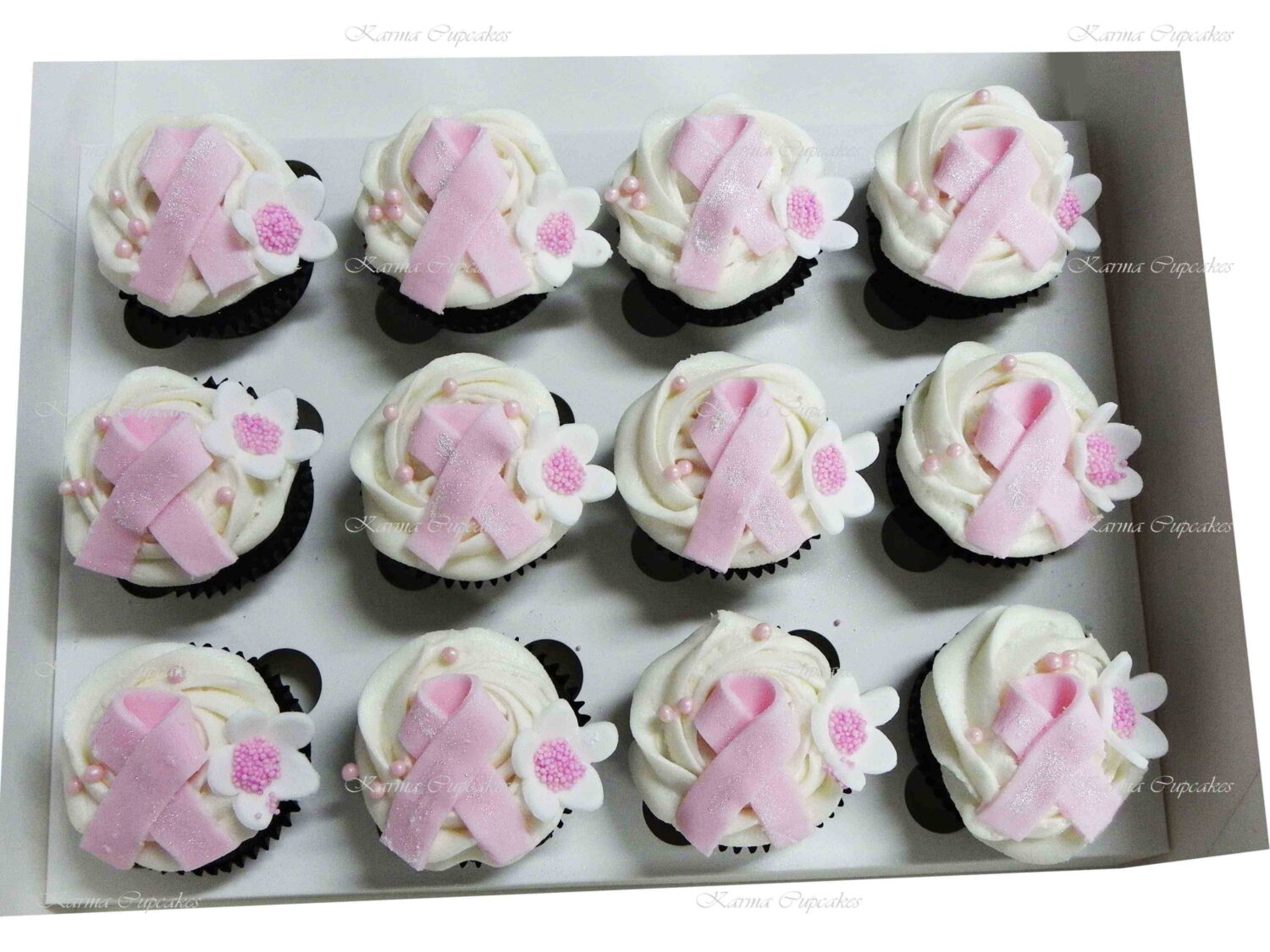 Breast Cancer Pink Ribbon Cupcakes with a rose swirl of buttercream icing.